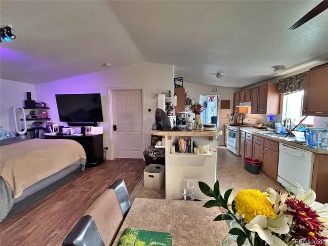 a bed room with furniture and a book shelf