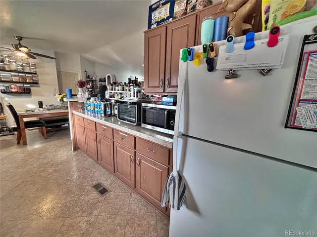 a kitchen with refrigerator a stove a washer and dryer