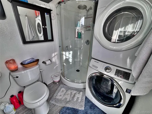 a bathroom with a toilet sink and shower