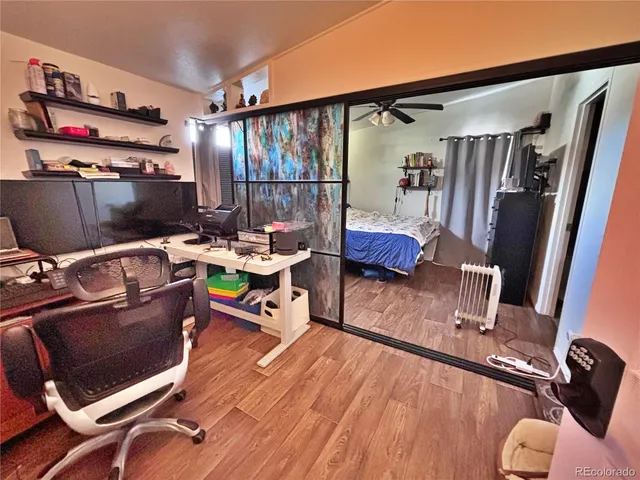 a bedroom with a bed and wooden floor