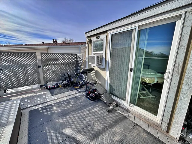 a roof deck with table and chairs