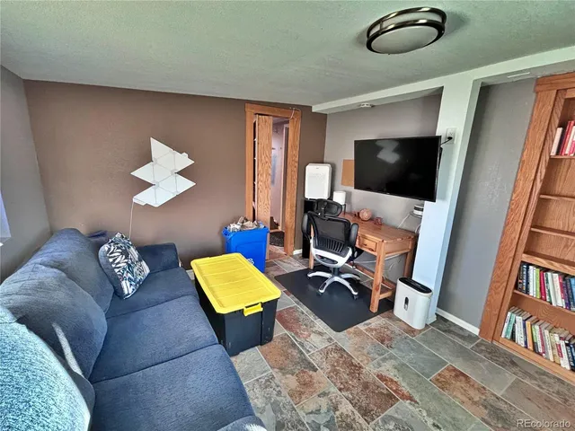 a bed room with a bed and a ceiling fan