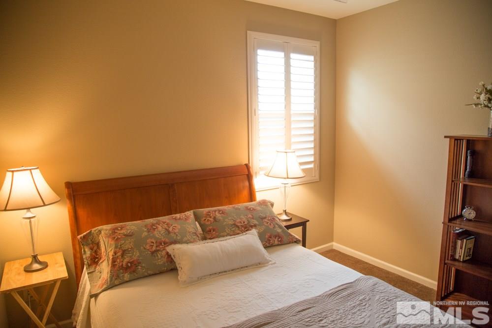 11061 Colton Drive Reno, NV 89521 - Photo 11 of 24 a bedroom with a bed and a book shelf