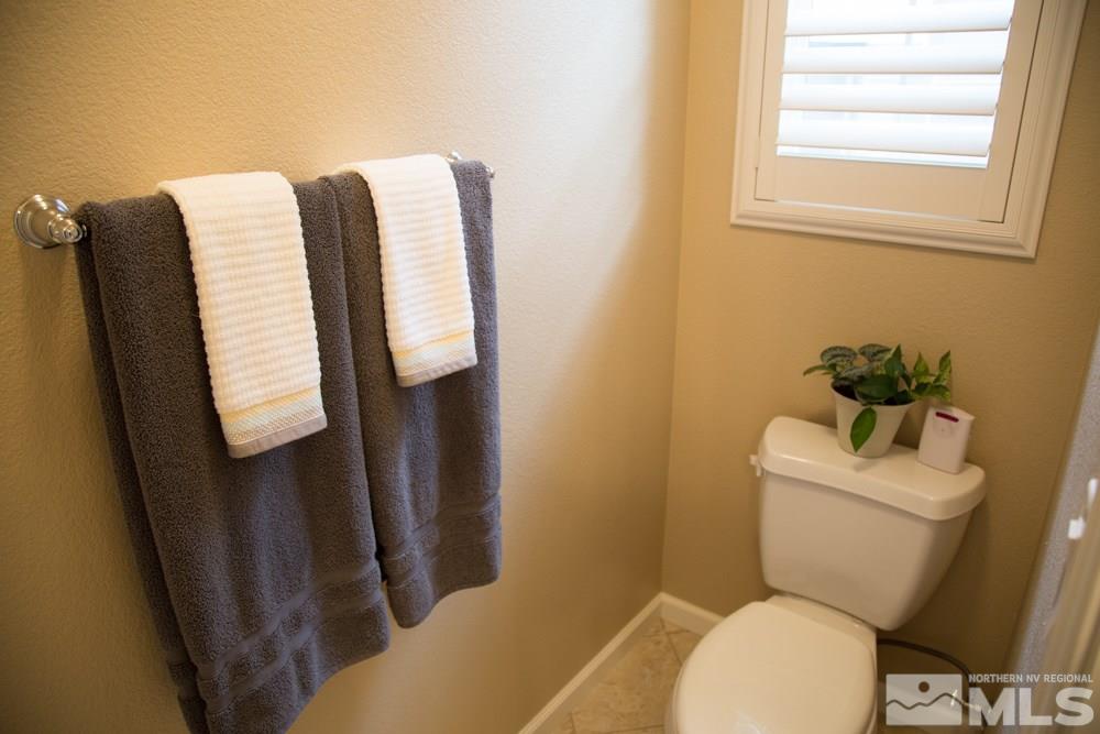 11061 Colton Drive Reno, NV 89521 - Photo 18 of 24 a white toilet sitting next to a bathroom sink