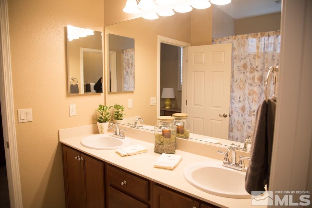 11061 Colton Drive Reno, NV 89521 - Photo 19 of 24 a bathroom with a sink double vanity and a mirror