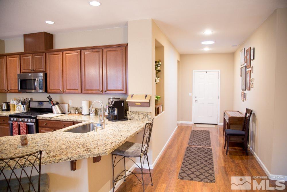 11061 Colton Drive Reno, NV 89521 - Photo 8 of 24 a kitchen with granite countertop lots of counter top space appliances and cabinets