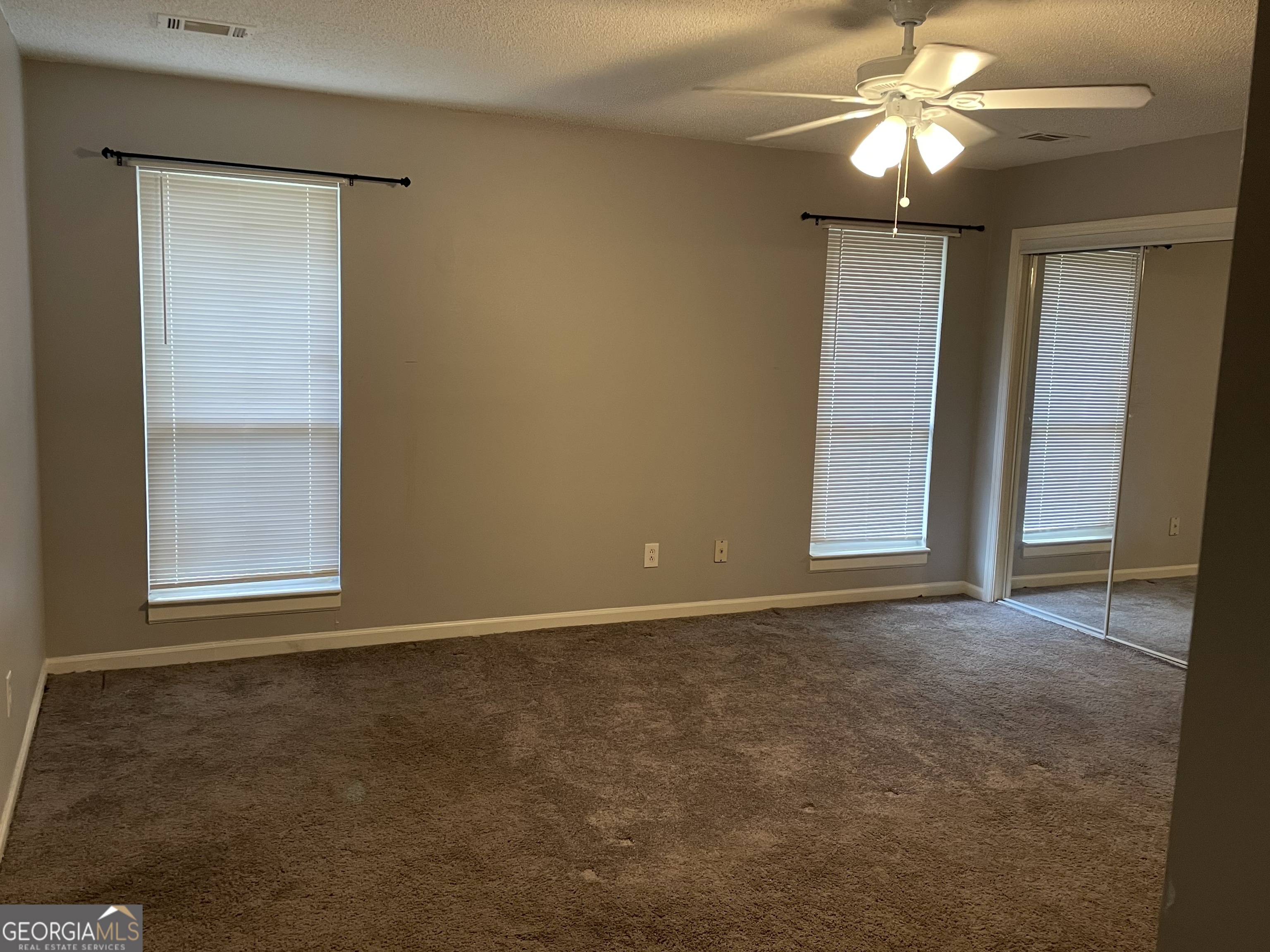 6720 Branch Drive Rex, GA 30273 - Photo 7 of 10 an empty room with windows and fan