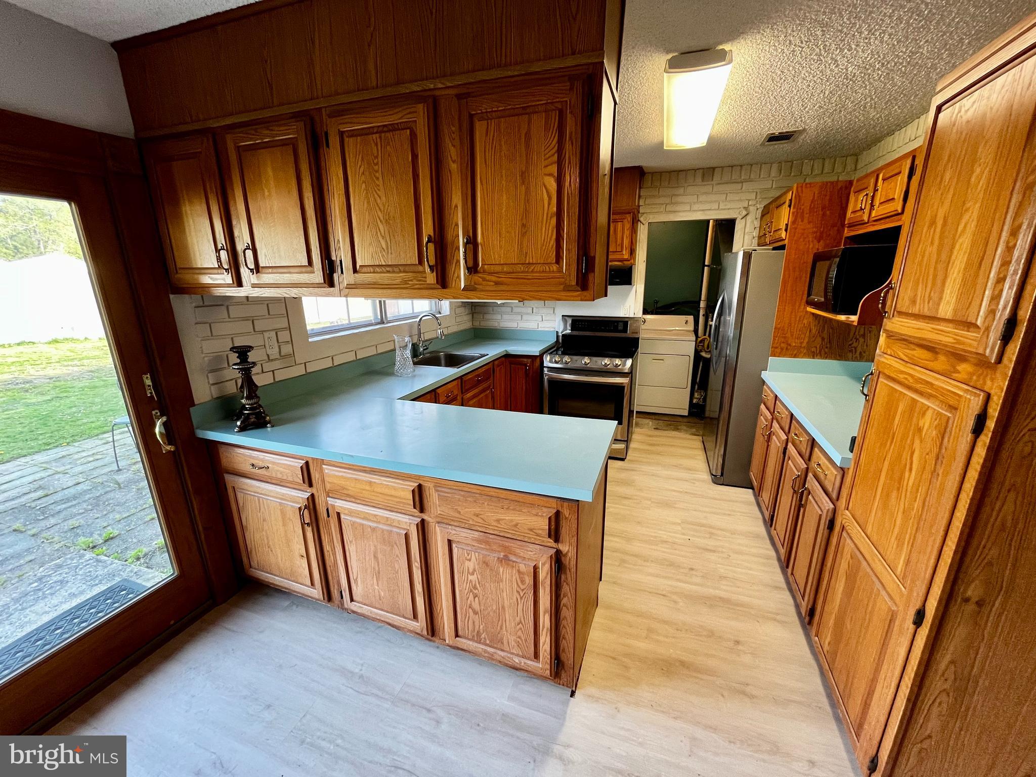 1 Hornsby Drive Marlton, NJ 08053 - Photo 7 of 22 a kitchen with stainless steel appliances granite countertop a stove a sink and a refrigerator