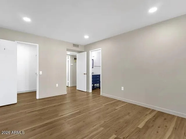 a view of an empty room with wooden floor