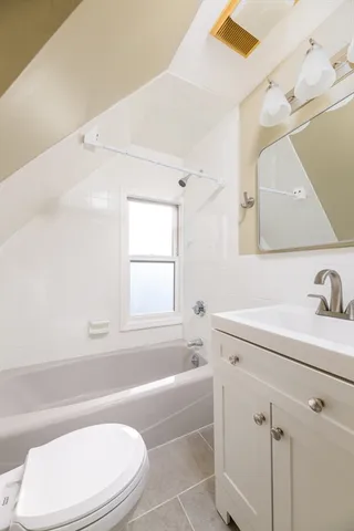 a bathroom with a sink a toilet and bathtub
