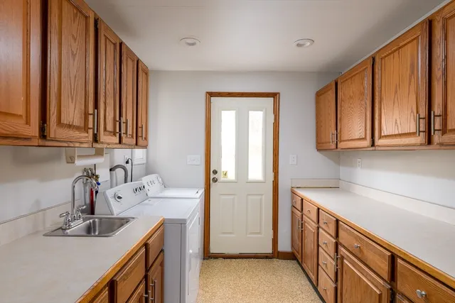 a kitchen with a sink cabinets and window