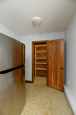 a view of walk in closet with clothes