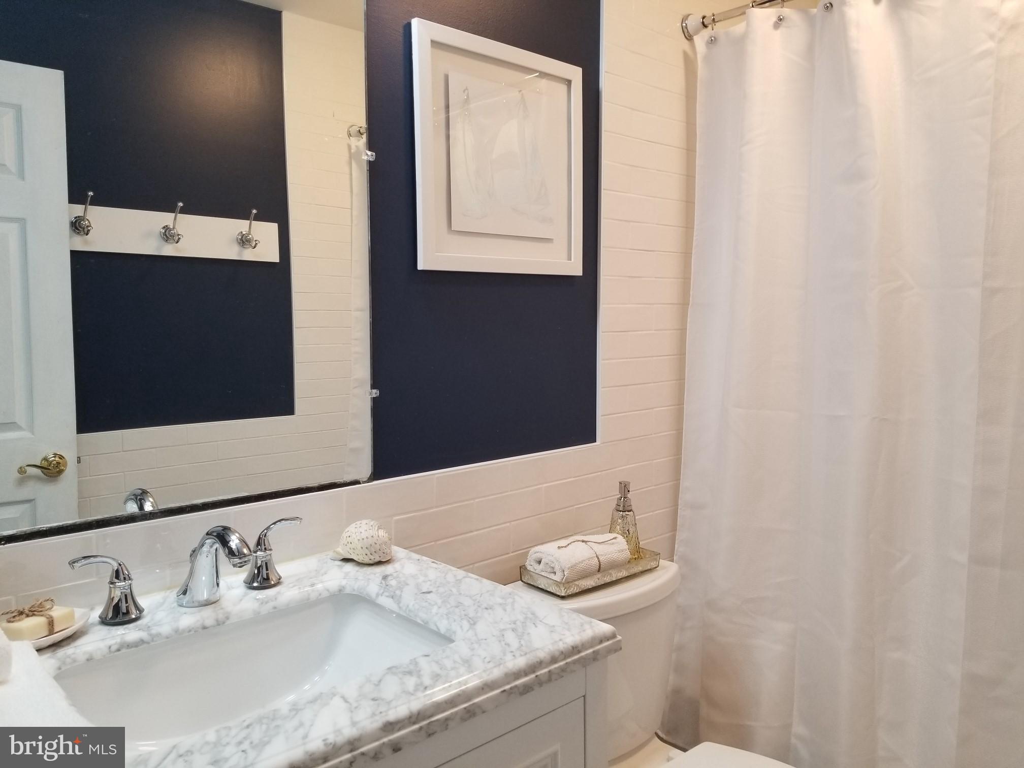 1404 Hunting Wood Road Annapolis, MD 21403 - Photo 8 of 15 a bathroom with a granite countertop sink and a mirror