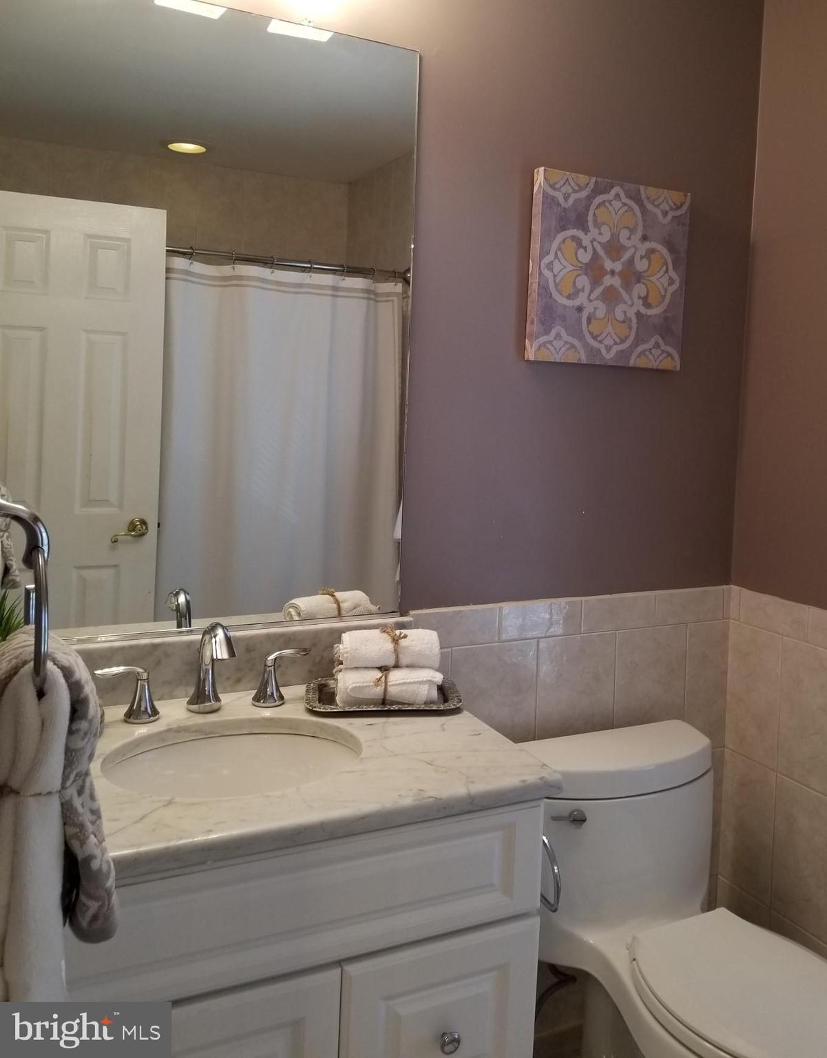 1404 Hunting Wood Road Annapolis, MD 21403 - Photo 9 of 15 a bathroom with a sink a toilet and mirror