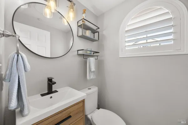 a bathroom with a sink mirror and toilet