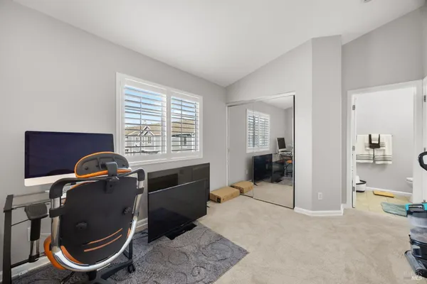 a view of a workspace with furniture and window
