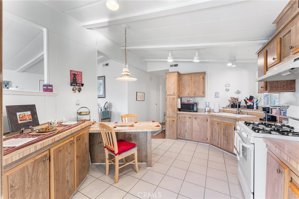692 North Adele, Unit 64 Orange, CA 92867 - Photo 6 of 16 a kitchen that has a lot of cabinets in it and appliances