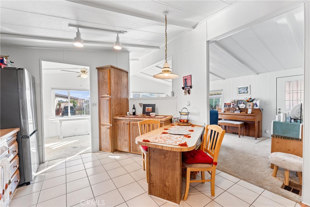 692 North Adele, Unit 64 Orange, CA 92867 - Photo 7 of 16 a dining room with furniture a kitchen view and chandelier