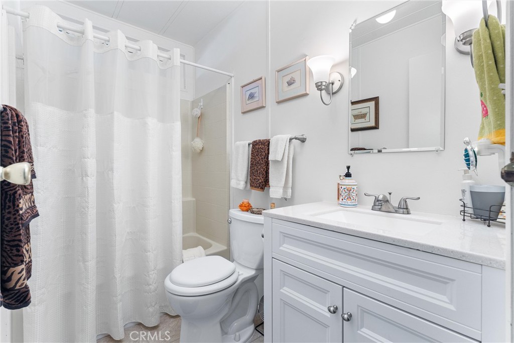 692 North Adele, Unit 64 Orange, CA 92867 - Photo 10 of 16 a bathroom with a sink a toilet and a mirror