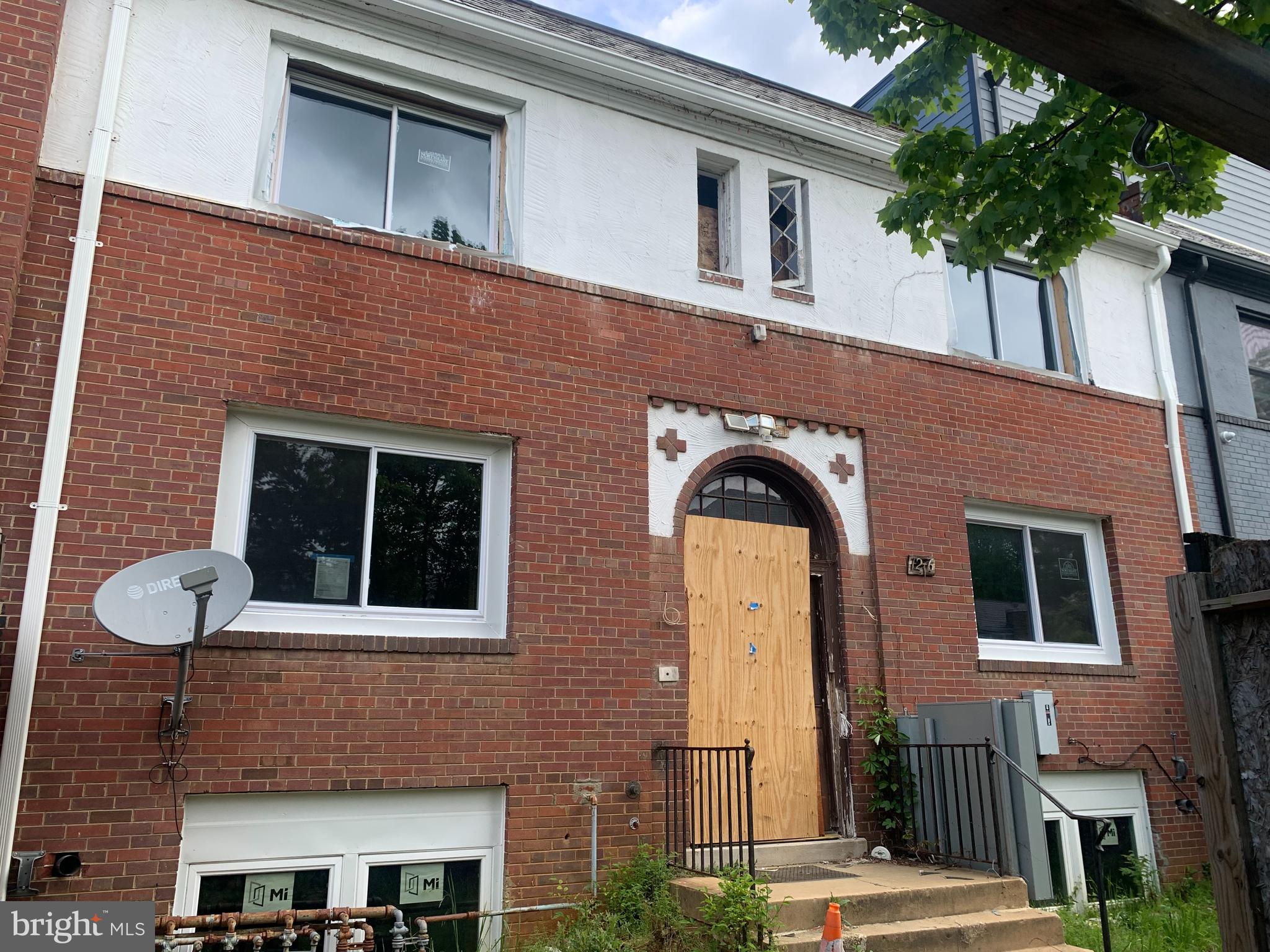 a front view of a house with plants