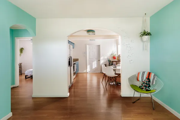 a living room with dining room and wooden floor