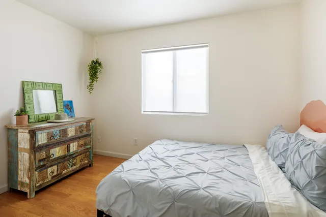 a bedroom with a bed and a window