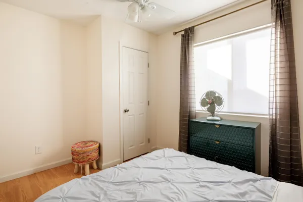 a bedroom with a bed and a window