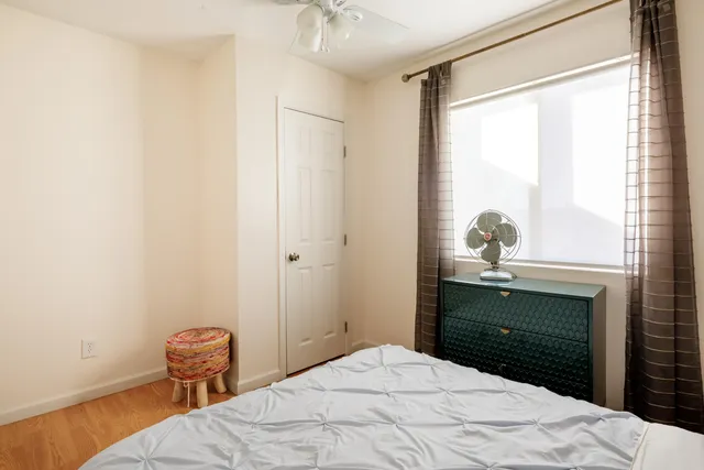 a bedroom with a bed and a window