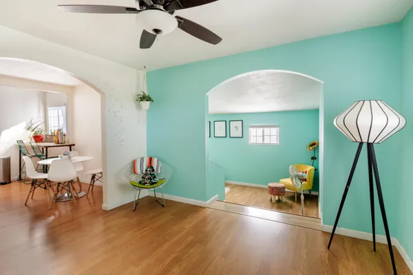 a living room with furniture and a wooden floor