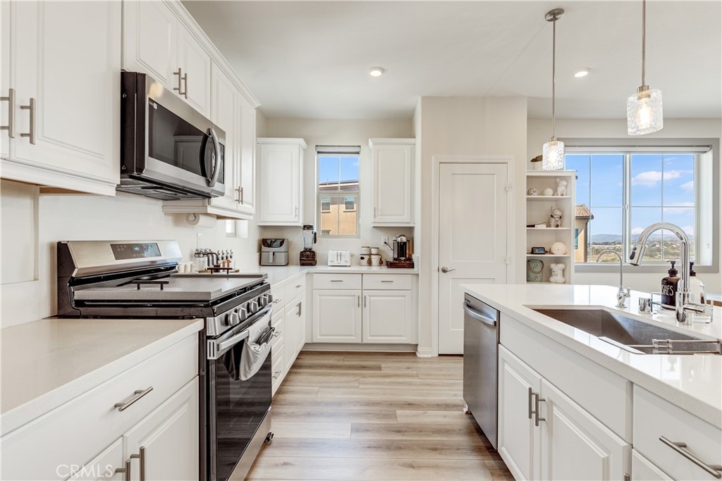 1648 Fig Tree Way Oceanside, CA 92056 - Photo 11 of 45 a kitchen with stainless steel appliances granite countertop a sink and a stove