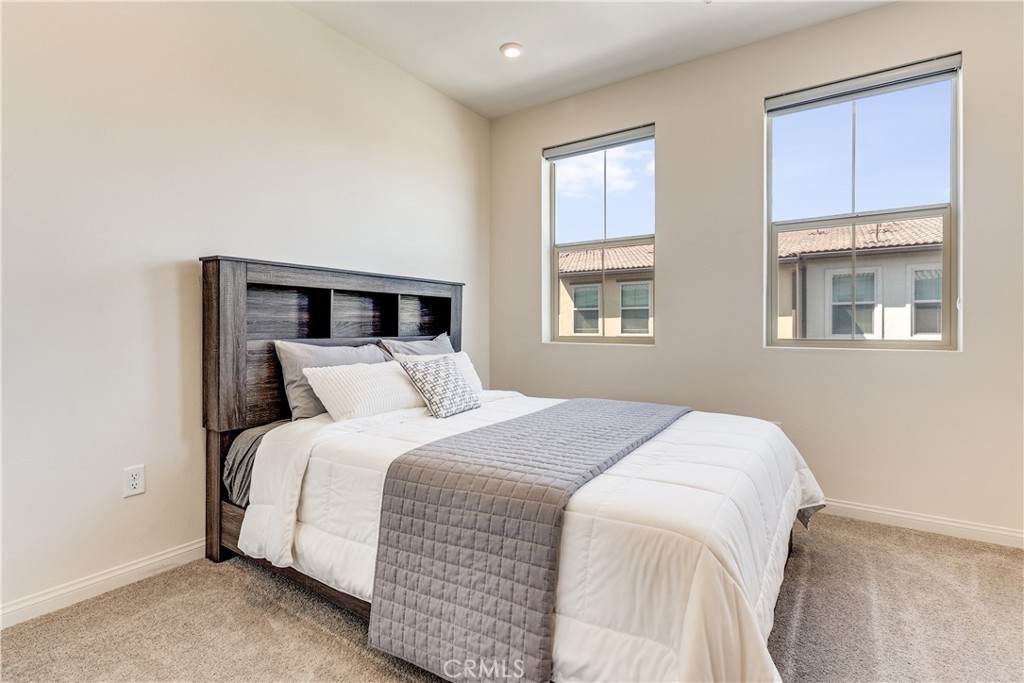 1648 Fig Tree Way Oceanside, CA 92056 - Photo 25 of 45 a bedroom with a bed and a window