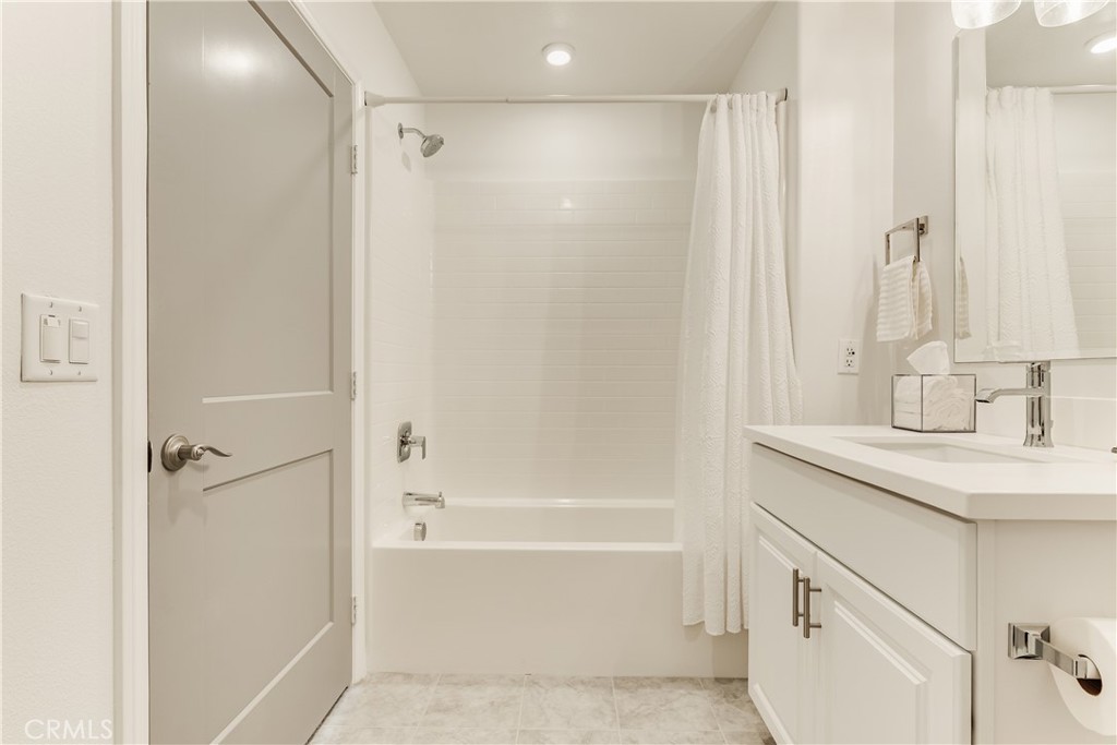 1648 Fig Tree Way Oceanside, CA 92056 - Photo 28 of 45 a bathroom with a shower sink vanity and mirror