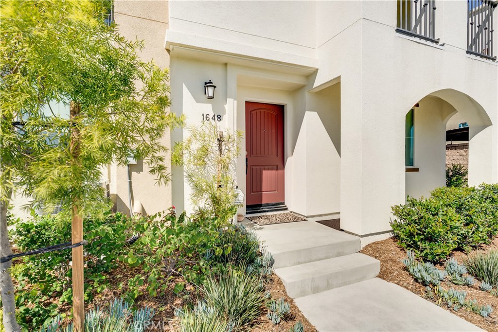 1648 Fig Tree Way Oceanside, CA 92056 - Photo 3 of 45 a front view of a house with plants
