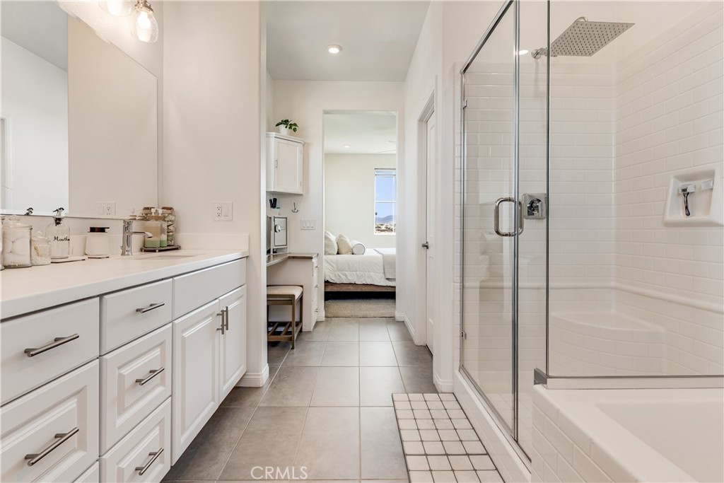 1648 Fig Tree Way Oceanside, CA 92056 - Photo 36 of 45 a bathroom with a double vanity sink a toilet and a shower