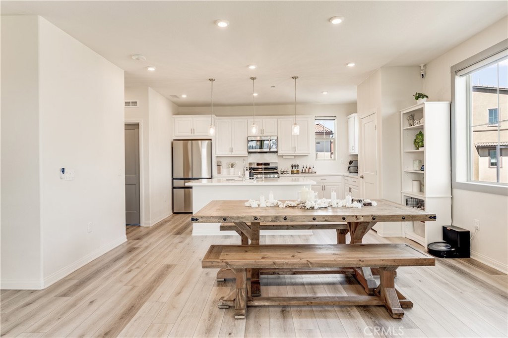 1648 Fig Tree Way Oceanside, CA 92056 - Photo 8 of 45 a living room with stainless steel appliances kitchen island granite countertop furniture and a view of kitchen