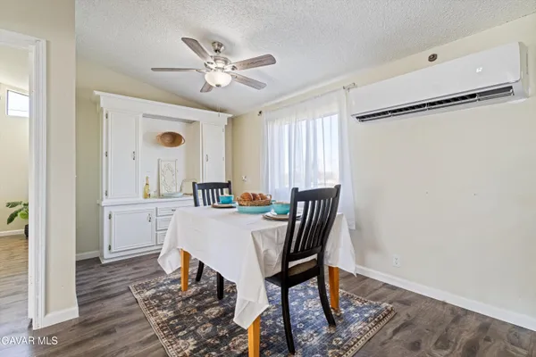 a view of a dining room with furniture and wooden floor