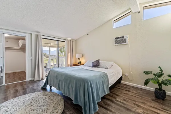 a bedroom with bed and wooden floor