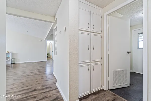 a view of a hallway with wooden floor