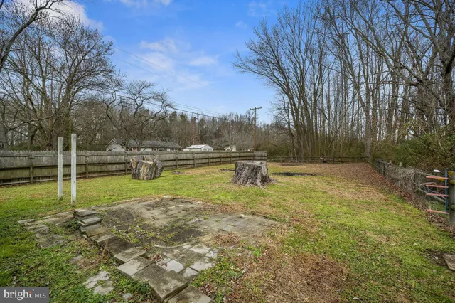 a view of yard with swimming pool and green space