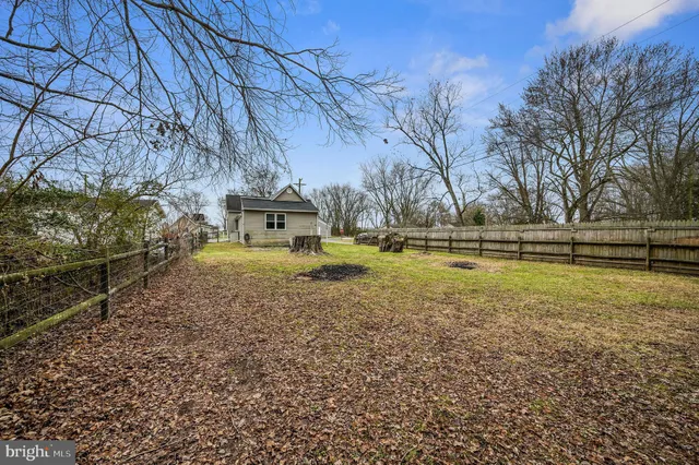 a view of yard with swimming pool and green space