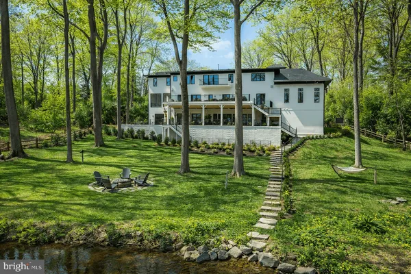 a view of a house with a backyard and a tree