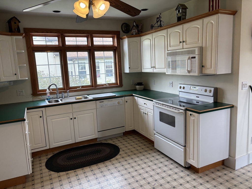 577 County Street Taunton, MA 02780 - Photo 4 of 23 a kitchen with stainless steel appliances granite countertop a sink a stove and a microwave oven