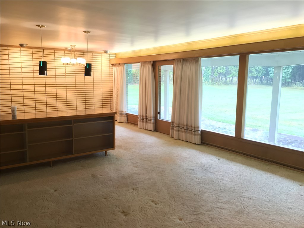 7457 Warren - Sharon Road Brookfield, OH 44403 - Photo 3 of 24 Floor-to-ceiling windows in the living/dining room, with access to back patio.