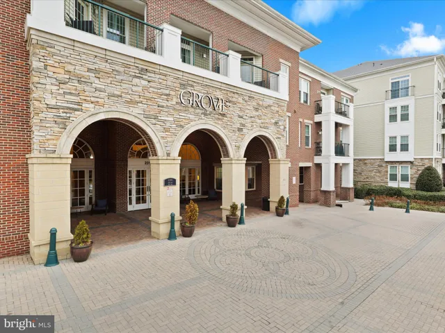 a living room with furniture potted plant and a large window