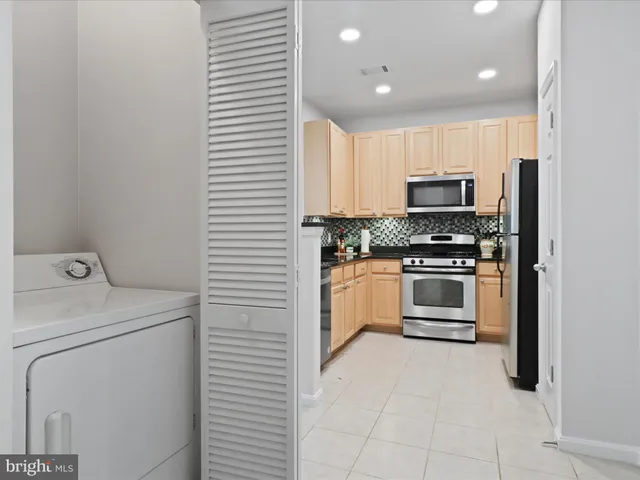 a kitchen with a stove a sink and a microwave