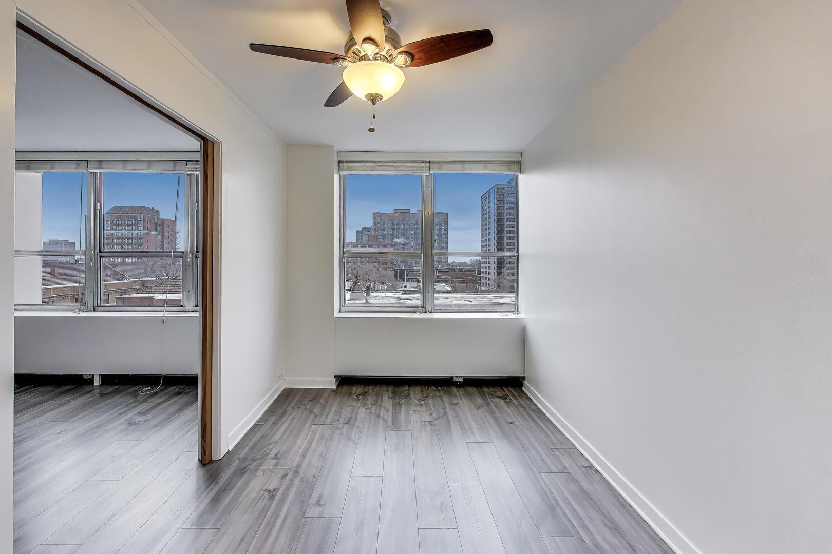 655 West Irving Park Road, Unit 606 Chicago, IL 60613 - Photo 12 of 28 a view of room with window and wooden floor
