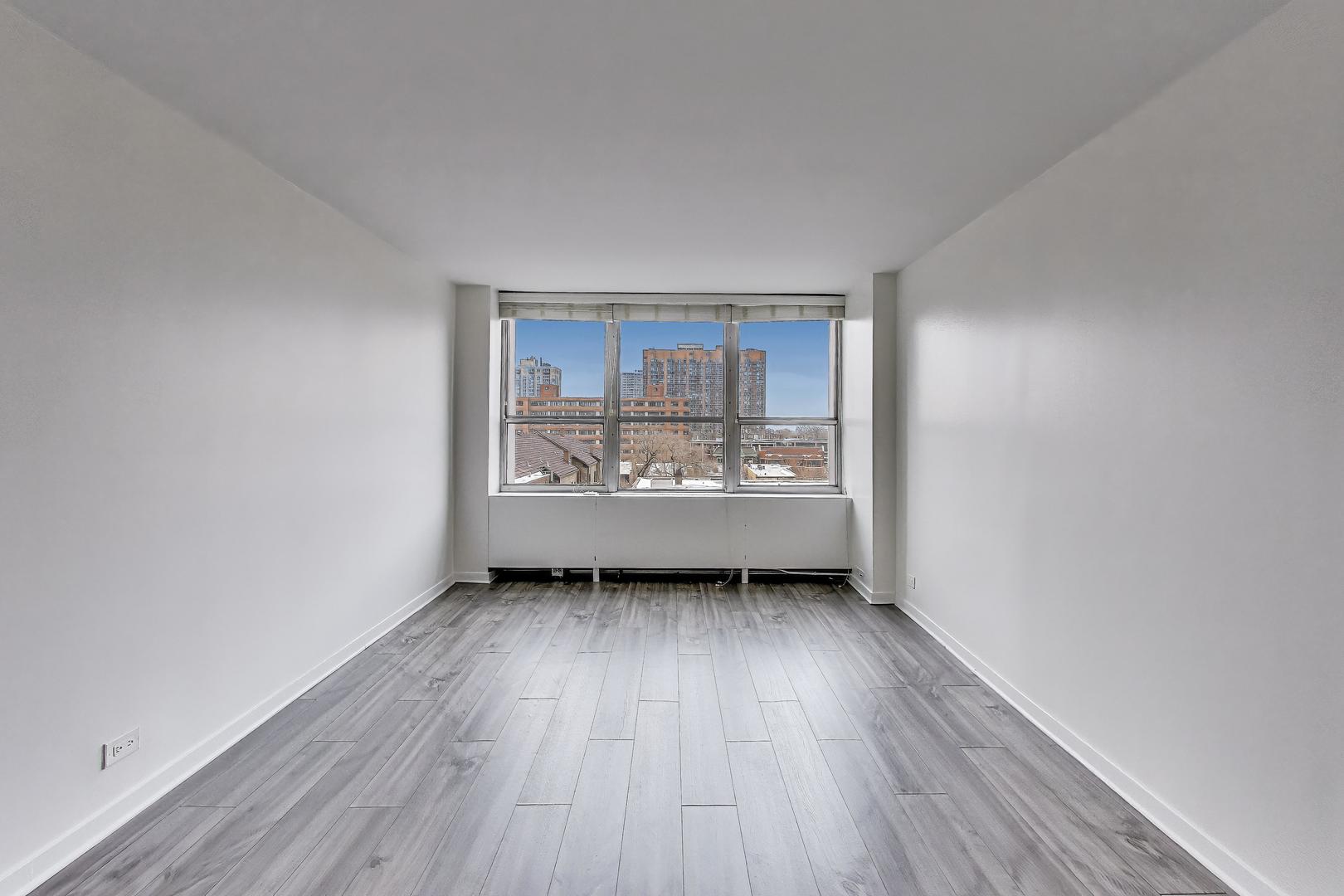 655 West Irving Park Road, Unit 606 Chicago, IL 60613 - Photo 14 of 28 a view of a room with wooden floor and window