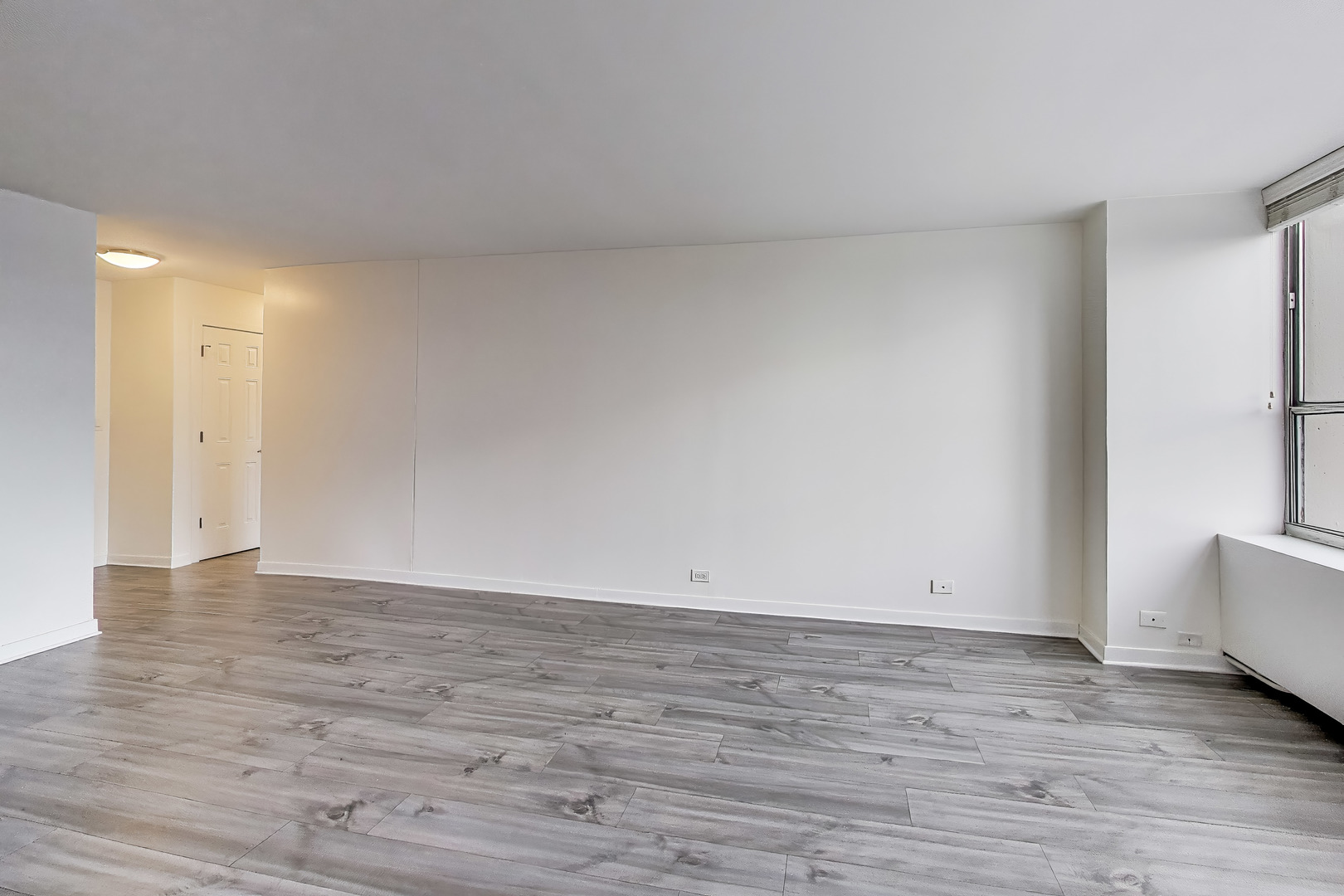655 West Irving Park Road, Unit 606 Chicago, IL 60613 - Photo 7 of 28 a view of an empty room and wooden floor