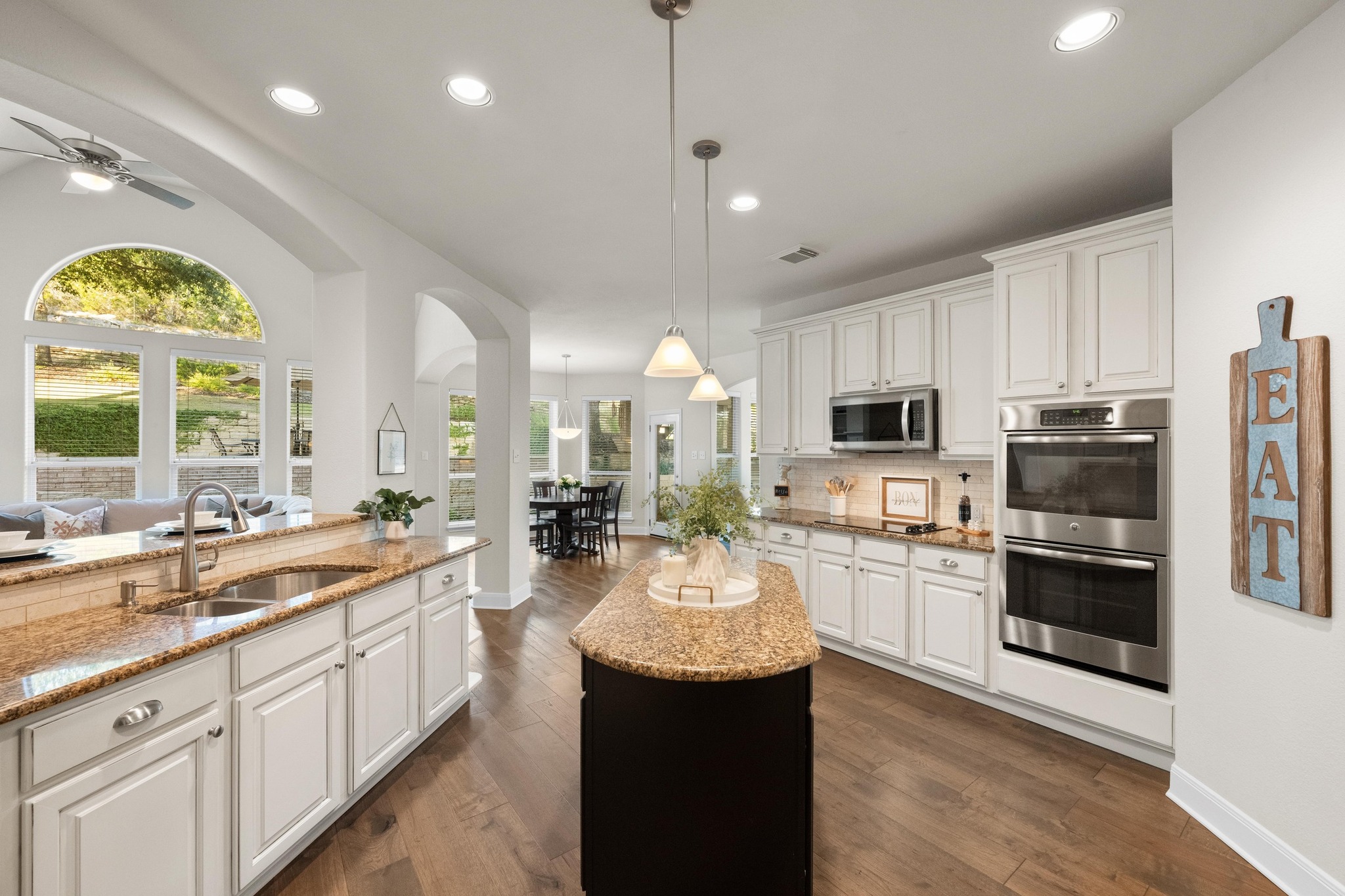 3713 Soledad Court Austin, TX 78732 - Photo 13 of 40 a large kitchen with kitchen island lots of counter space a sink appliances and a large window
