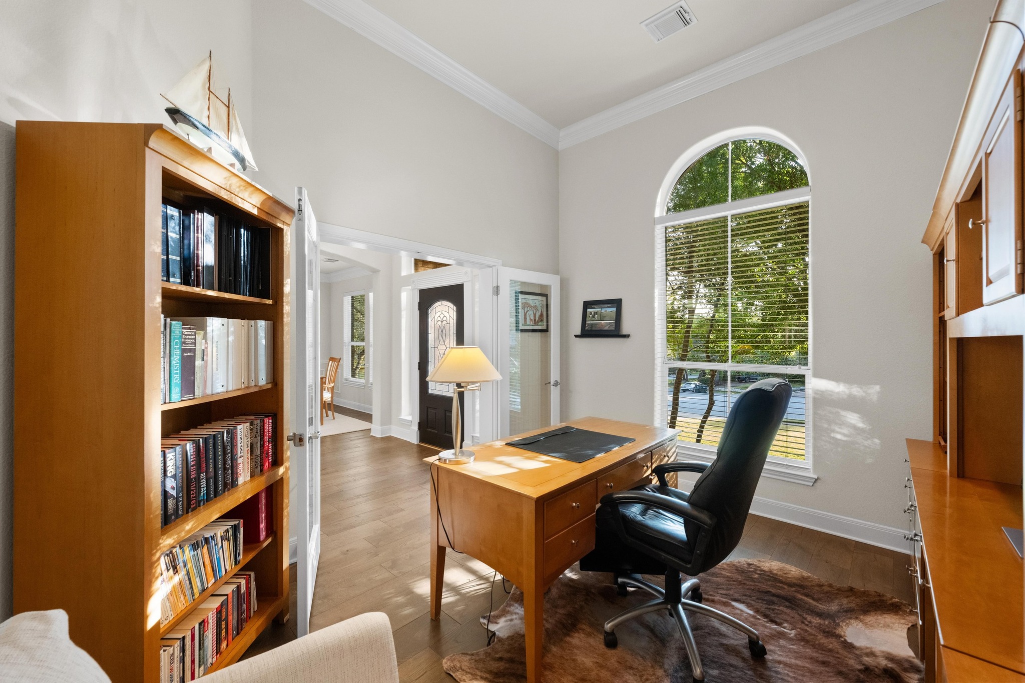 3713 Soledad Court Austin, TX 78732 - Photo 14 of 40 a view of a workspace with furniture and a bookshelf
